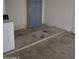 An interior of a garage showing a storage cabinet, a step-up, and washer and dryer hookups at 5139 E Tano St, Phoenix, AZ 85044