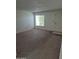 Spacious living room with neutral carpet, ample natural light, and fresh, neutral paint at 5139 E Tano St, Phoenix, AZ 85044