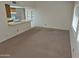 Open living room with an adjacent kitchen bar and plenty of natural light at 5139 E Tano St, Phoenix, AZ 85044