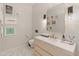 Stylish powder room with marble floors, floating vanity with gold faucet and decorative wall art at 523 W Vista Ave, Phoenix, AZ 85021