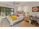 Bright bedroom featuring hardwood floors, a large slider window and a cozy contemporary style at 523 W Vista Ave, Phoenix, AZ 85021