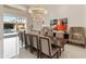 Elegant dining room featuring a large dining table, modern chandelier, and poolside view at 523 W Vista Ave, Phoenix, AZ 85021