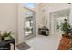 Bright, modern entryway featuring sleek white tile, statement lighting, and a view to a private courtyard at 523 W Vista Ave, Phoenix, AZ 85021