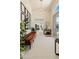 Bright and spacious foyer featuring a tufted bench, modern light fixture, and view of the open-concept living spaces at 523 W Vista Ave, Phoenix, AZ 85021