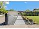 Charming home with desert landscaping, including square sidewalk stones and decorative rocks, plus a well-manicured lawn at 523 W Vista Ave, Phoenix, AZ 85021