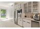 Kitchen with white cabinetry, stainless steel appliances, a built in sink, wine fridge, and door to the yard at 523 W Vista Ave, Phoenix, AZ 85021
