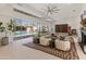 Open-concept living room with a fireplace, high ceilings, modern furnishings, and a view to the pool at 523 W Vista Ave, Phoenix, AZ 85021