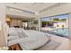 Bright main bedroom with floor to ceiling windows overlooking the pool and patio at 523 W Vista Ave, Phoenix, AZ 85021