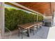 Spacious covered patio with a large wooden dining table, ample seating, and outdoor lounge area at 523 W Vista Ave, Phoenix, AZ 85021