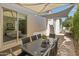Covered patio with travertine floors and outdoor dining table with seating at 523 W Vista Ave, Phoenix, AZ 85021