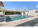 A well-maintained backyard pool with a covered patio with outdoor dining and lounge furniture at 523 W Vista Ave, Phoenix, AZ 85021