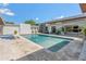 Luxury backyard pool with travertine decking, landscaping, covered patio, and tranquil water feature at 523 W Vista Ave, Phoenix, AZ 85021