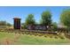Tierra Montana community entrance featuring beautiful landscaping and signage at 5428 W Jackalope Ln, Laveen, AZ 85339