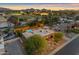 Spacious backyard with a pool, lush landscaping, and outdoor lighting for evening enjoyment at 5837 E Presidio Rd, Scottsdale, AZ 85254