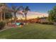 Expansive backyard with a pool, pergola, lush lawn, and inviting outdoor spaces at 5837 E Presidio Rd, Scottsdale, AZ 85254