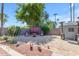 Cozy backyard patio area with seating, a shed, and lush greenery providing a tranquil outdoor living space at 5837 E Presidio Rd, Scottsdale, AZ 85254
