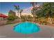 An inviting backyard pool surrounded by lush greenery, mature trees, and comfortable seating for outdoor entertaining and relaxation at 5837 E Presidio Rd, Scottsdale, AZ 85254