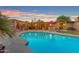A beautiful backyard pool and patio area featuring a table with umbrella perfect for relaxing and entertaining outdoors at 5837 E Presidio Rd, Scottsdale, AZ 85254