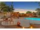 Outdoor living with a pergola, dining area, lush greenery, and a pool make this home perfect for entertaining and relaxing at 5837 E Presidio Rd, Scottsdale, AZ 85254