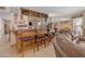 Finished basement bar with dark wood cabinets, tiled floors, and seating for four at 5837 E Presidio Rd, Scottsdale, AZ 85254