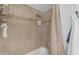 Bathroom featuring a tiled shower, built-in niche, and tiled walls at 5837 E Presidio Rd, Scottsdale, AZ 85254