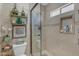 Bathroom featuring a glass shower, decorative shelving, and stylish tile work at 5837 E Presidio Rd, Scottsdale, AZ 85254