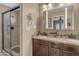 Bathroom features granite countertops, dual sinks, dark wood cabinets, and an enclosed shower at 5837 E Presidio Rd, Scottsdale, AZ 85254