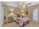 Bedroom featuring a ceiling fan, bedside lamps, a decorative headboard, and window at 5837 E Presidio Rd, Scottsdale, AZ 85254