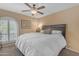 Cozy bedroom with a ceiling fan, a large window, and comfortable furnishings at 5837 E Presidio Rd, Scottsdale, AZ 85254