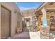 Charming outdoor patio area with a pergola, decorative accents, and desert landscaping at 5837 E Presidio Rd, Scottsdale, AZ 85254