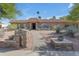 Inviting single-story home with meticulously maintained desert landscaping and a brick-paved walkway at 5837 E Presidio Rd, Scottsdale, AZ 85254