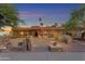 Charming home exterior with tile roof, stone accents, desert landscaping, and a welcoming walkway at 5837 E Presidio Rd, Scottsdale, AZ 85254