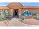 Inviting home exterior featuring a tiled roof, stone pillars, desert landscaping, and a welcoming walkway at 5837 E Presidio Rd, Scottsdale, AZ 85254