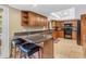 This kitchen boasts granite countertops, dark appliances, a breakfast bar, and beautiful wood cabinetry at 5837 E Presidio Rd, Scottsdale, AZ 85254