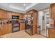 Bright kitchen features tiled floors, granite countertops, wood cabinets, and stainless steel appliances at 5837 E Presidio Rd, Scottsdale, AZ 85254