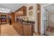 Functional kitchen with wooden cabinets, granite countertops, and convenient access to the laundry area at 5837 E Presidio Rd, Scottsdale, AZ 85254