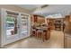 Well-equipped kitchen with a breakfast bar, tile flooring, and seamless access to the outdoor patio and pool at 5837 E Presidio Rd, Scottsdale, AZ 85254