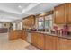 Well-lit kitchen with dark countertops, wooden cabinetry, and a seamless transition to the living spaces at 5837 E Presidio Rd, Scottsdale, AZ 85254