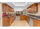 Spacious kitchen offers wood cabinets, granite counters, and an open layout to other living areas at 5837 E Presidio Rd, Scottsdale, AZ 85254
