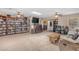 Cozy living room with built-in bookshelves, a ceiling fan, and a large wooden table at 5837 E Presidio Rd, Scottsdale, AZ 85254