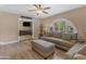 Comfortable living room boasts a ceiling fan and plenty of natural light through a large window at 5837 E Presidio Rd, Scottsdale, AZ 85254
