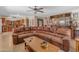 Open-concept living area features tile floors, a leather couch, and a bar at 5837 E Presidio Rd, Scottsdale, AZ 85254