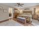 Bedroom features wood floors, neutral paint, ceiling fan, and an ensuite bathroom at 5837 E Presidio Rd, Scottsdale, AZ 85254