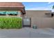 Side yard featuring a privacy gate, lush greenery, and colorful flowers at 5837 E Presidio Rd, Scottsdale, AZ 85254