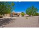 Expansive backyard featuring gravel landscaping, patio with outdoor seating, and mature trees for added privacy at 6337 E Evergreen St, Mesa, AZ 85205