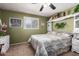 This bedroom boasts a ceiling fan, a neutral color scheme, and soft carpet at 6337 E Evergreen St, Mesa, AZ 85205