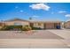 Charming single-story home with well-maintained landscaping and a covered carport at 6337 E Evergreen St, Mesa, AZ 85205
