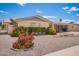 Charming home with desert landscaping, flowering shrubs, and a covered carport at 6337 E Evergreen St, Mesa, AZ 85205