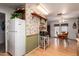 Bright eat-in kitchen with white appliances, natural wood cabinets, and a charming dining area at 6337 E Evergreen St, Mesa, AZ 85205