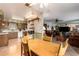 Bright kitchen area with an open concept to living room, wood table, and vintage accents at 6337 E Evergreen St, Mesa, AZ 85205